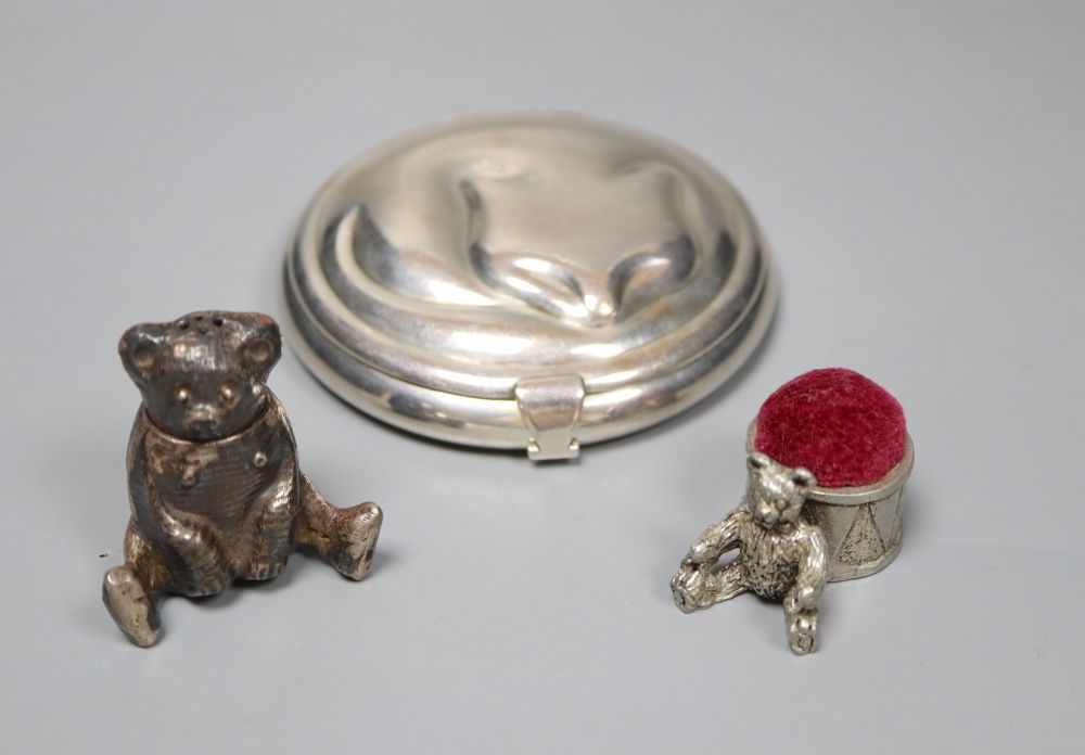 A Tiffany sterling silver circular cat compact, a white metal teddy bear pepper and a pewter teddy bear pin cushion